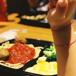 a child&apos;s hand holding a fork