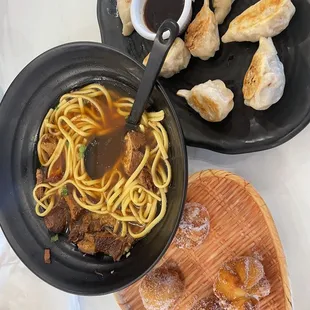a plate of dumplings and a bowl of soup
