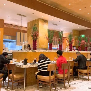 people sitting at tables in a restaurant