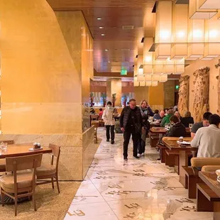 a restaurant with people eating and drinking