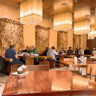 people sitting at tables in a restaurant