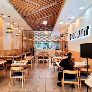 a woman sitting at a table in a restaurant