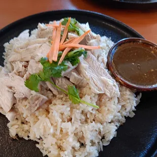 Boiled chicken, rice, and a spiced garlic sauce to pour over it.