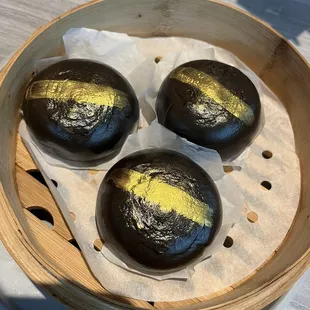 three chocolate buns in a bamboo basket