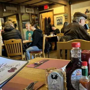 people sitting at tables in a restaurant