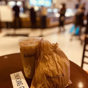 a bag of coffee and a drink on a table