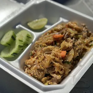 a take out container with rice and vegetables