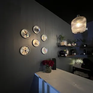 plates on the wall and a vase of flowers on the counter