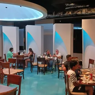 people sitting at tables in a restaurant