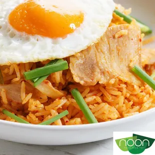a plate of rice with an egg on top