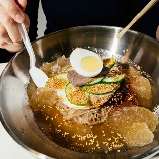 Icy-Spicy - Chilled buckwheat noodles topped with a fruit-bodied gochujang, pickled daikon, fresh cucumber a couple slivers of beef and egg.