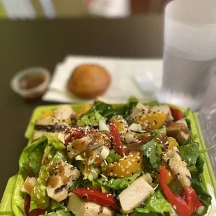 a salad with chicken, peppers, and lettuce