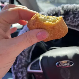 a hand holding a donut