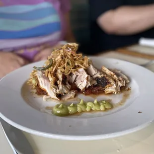 Grilled Ahi Tuna served on top of Sticky Rice, Charred Tomato Coulis, Wasabi, and Onion Slaw