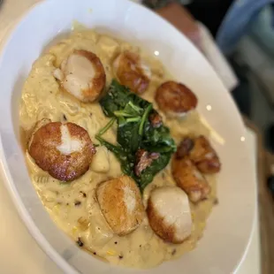 Scallop entree served over corn and potato chowder, crispy pork belly and seared spinach.