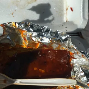 a piece of meat wrapped in aluminum foil