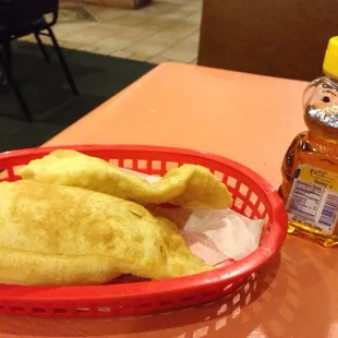 a basket of food and a bottle of honey