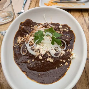 @endoedibles on Instagram 08/17/24
 
 ENMOLADAS - corn tortilla, queso fresco, mole poblano, onions, toasted sesame seeds