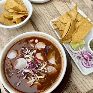 Pozole Rojo - Pork shoulder, hominy, ancho chile, radish, cabbage, lime, onion, oregano, tortilla chips.