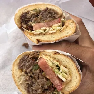 a hand holding a sandwich