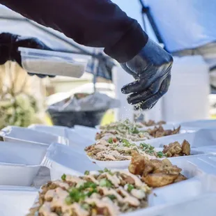 a person wearing gloves and gloves preparing food