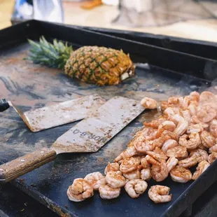 shrimp and pineapples on a grill