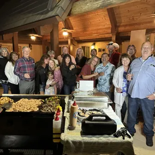 a group of people standing around a buffet table