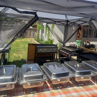a table with a variety of trays of food