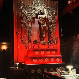 a statue of a person on a throne in a restaurant