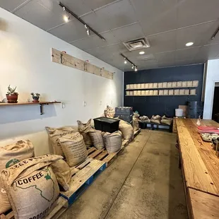 Bags of coffee beans next to the dining area of the coffee shop