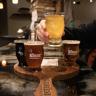 a person holding a glass of beer
