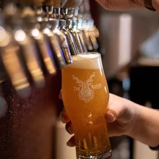 a person holding a glass of beer