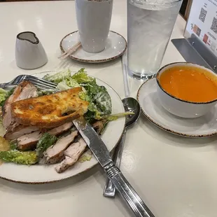 a plate of food and a cup of soup