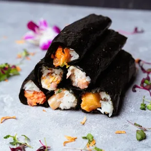 Bottom - spicy tuna, scallops, shrimp tempura  Middle - hamachi Top- salmon