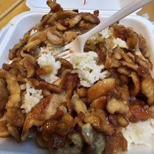 a takeout container with rice and meat
