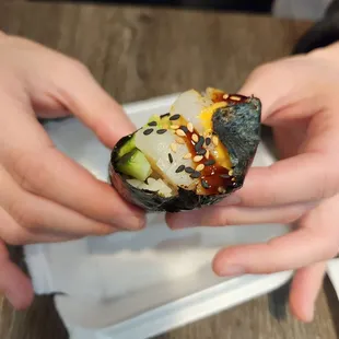 two hands holding a roll