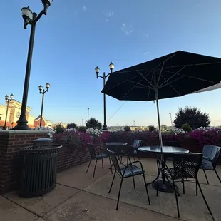 a patio with tables and umbrellas