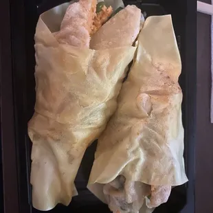 a close up of a roll with a side of rice