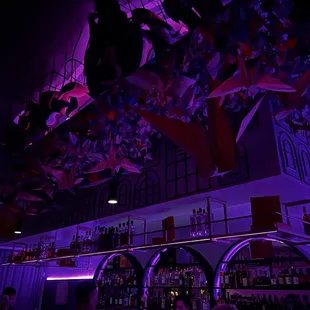 Precious Norigami speakeasy - cranes, flowers, pink neon.