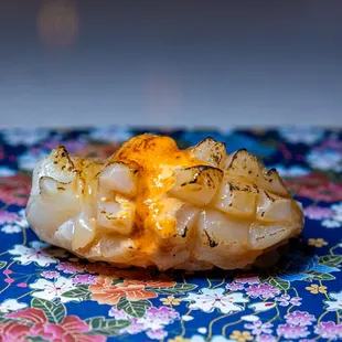 a close up of a potato covered in cheese