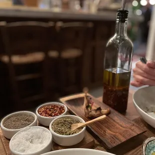 Chili oil, hot pepper flakes, oregano, salt and pepper