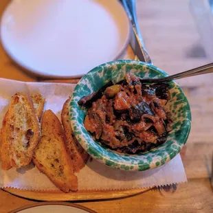 a bowl of sauce and bread