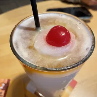 a drink with a cherry on top