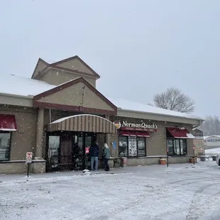 people standing outside in the snow