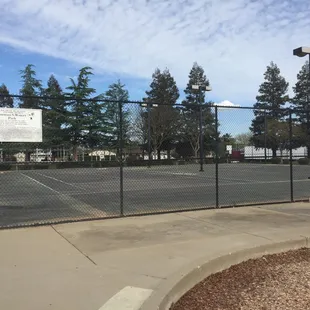 Tennis courts. There are no nets and doesn't look up kept