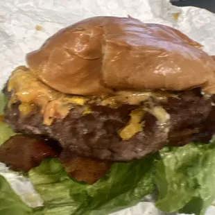 a hamburger with lettuce and cheese
