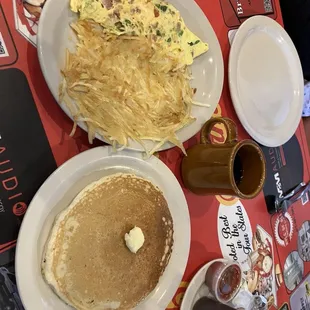 Everything omelette with a pancake and crispy hashbrowns.