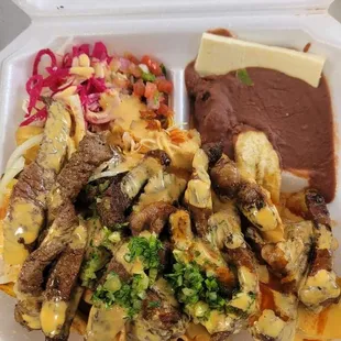 Carne Asada: Grilled steak served with fried green plantain strips, cabbage salad, refried beans, pico de gallo, cheese