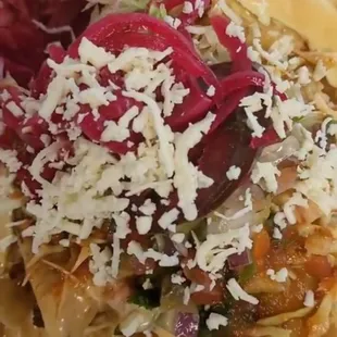 Honduran Tacos Flautas: Rolled chicken tacos served with cabbage salad, cheese, cream, &amp; side of fried plantain strips