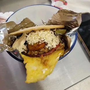 Honduran Breakfast Burrita: Fried sweet plantain, beans, cheese, cream, ham, avocado, egg, between 2 handmade corn tortillas